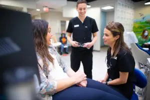 Dentists discussing treatment with patient