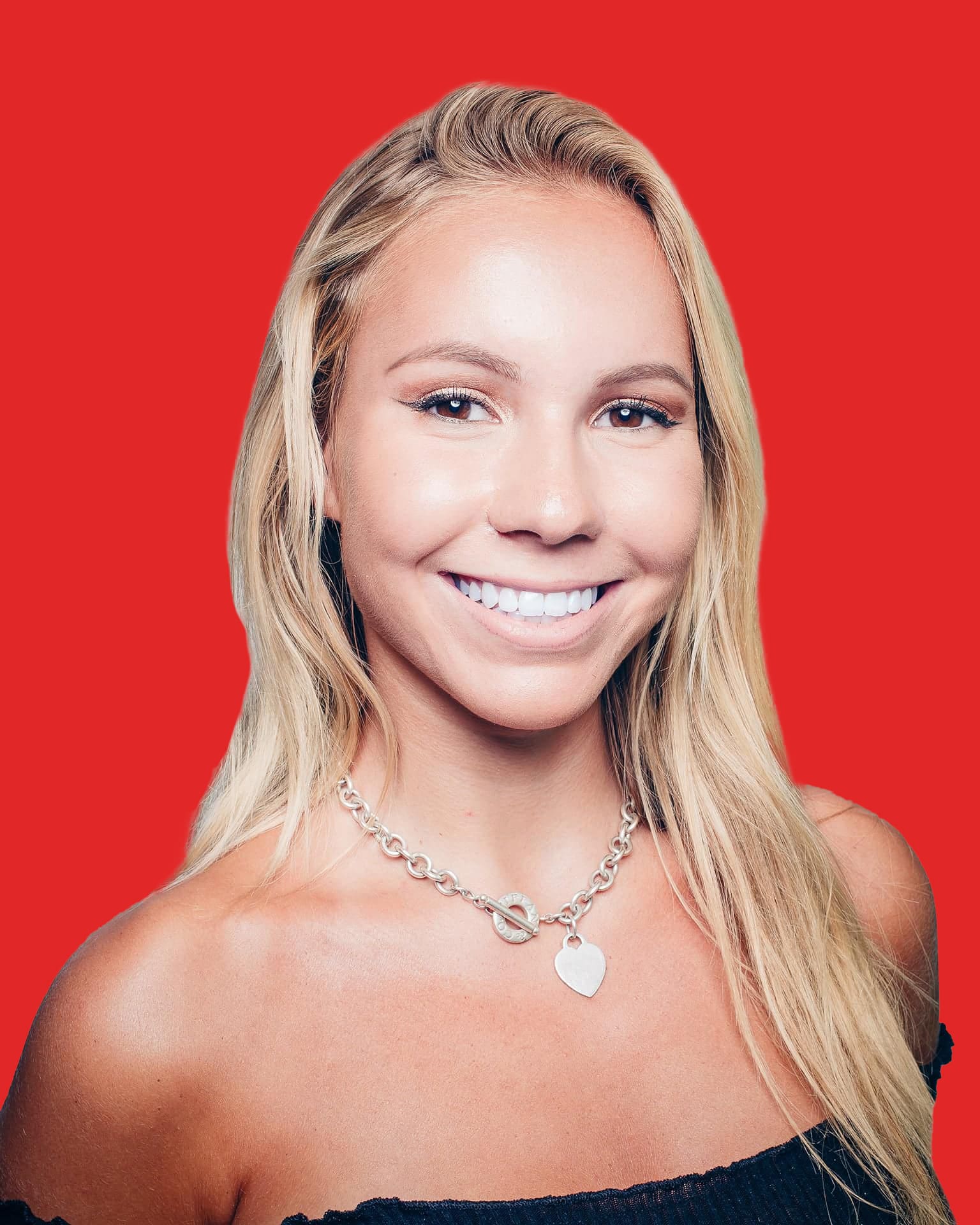 Smiling woman with necklace against red background