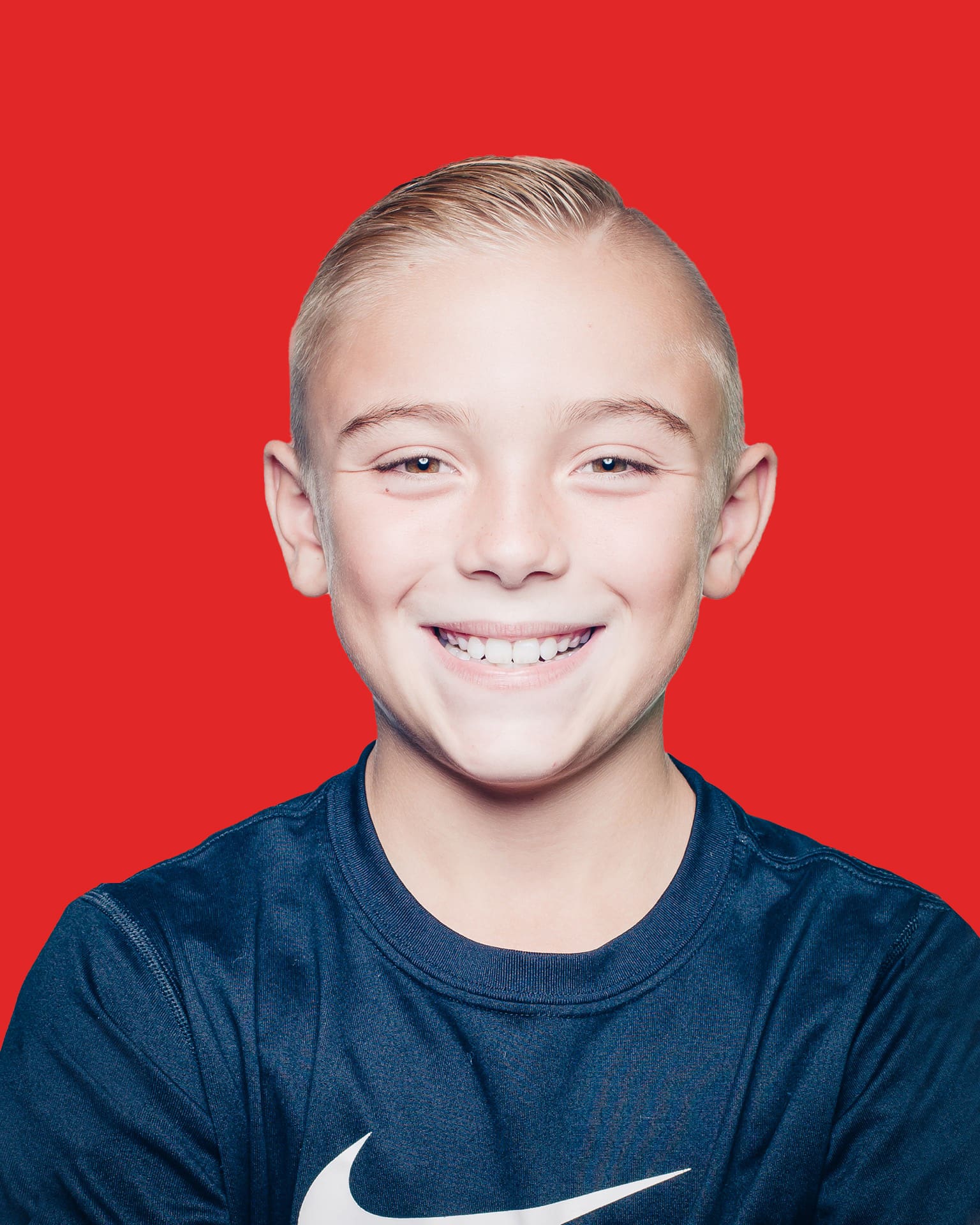 Smiling child on red background.